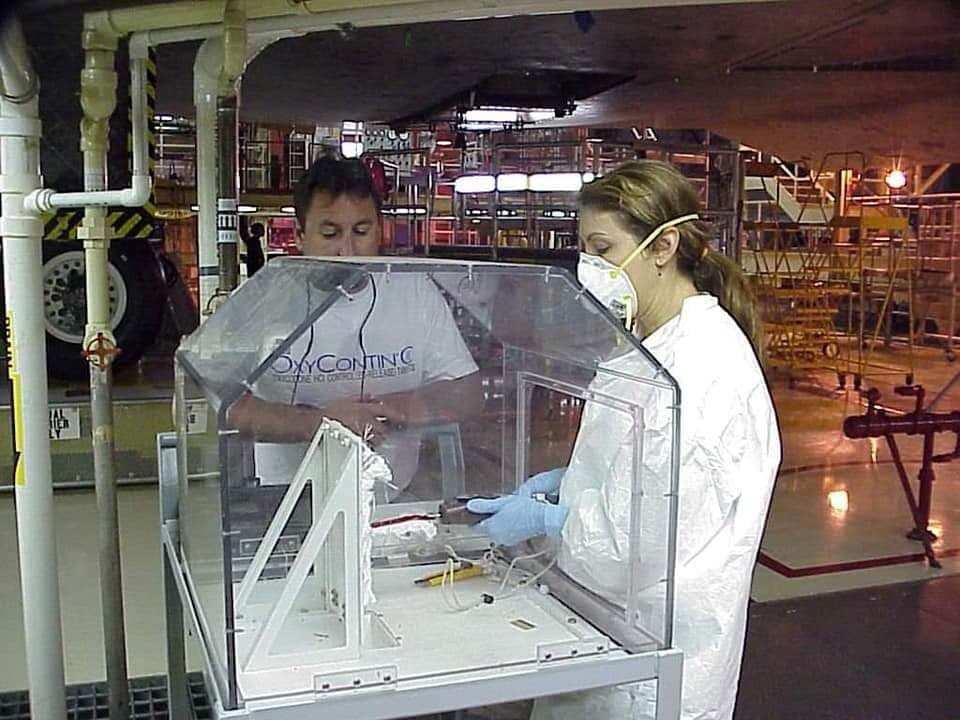 Eva performing mechanical tests on the bonding material used to attach the flexible insulation blankets to the Shuttle.